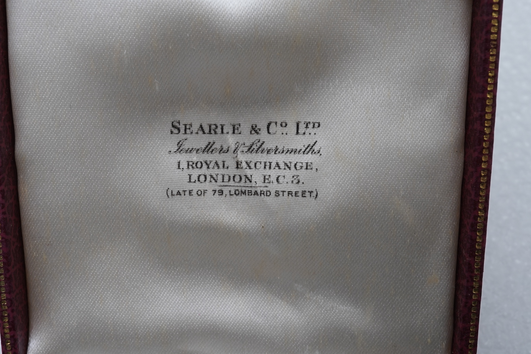 A gold watch chain, toothpick and fob seal